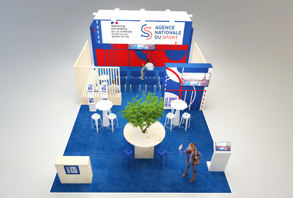Image du stand au salon des Maires 2025 présentant un écran, des chaises, des tables, l'habillage avec les logos du ministère des Sports et de l'ANS.