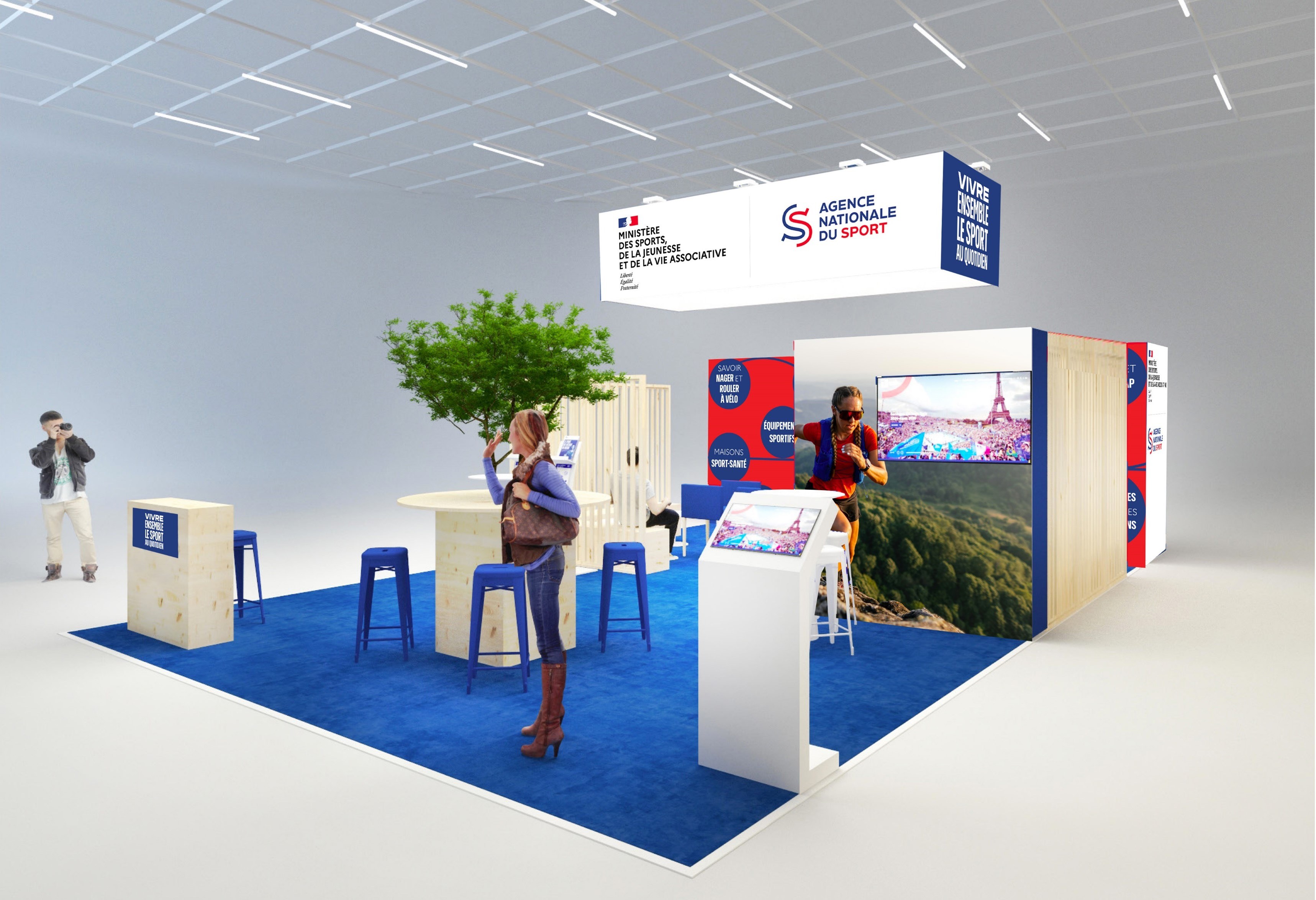 Image du stand au salon des Maires 2025 présentant un écran, des chaises, des tables, l'habillage avec les logos du ministère des Sports et de l'ANS.