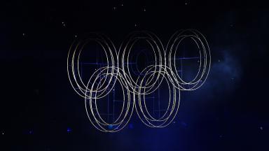 Image sombre avec anneaux olympiques lumineux